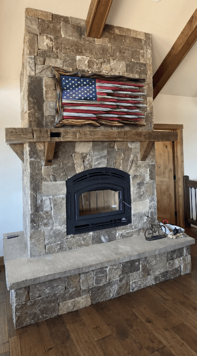 marksflags wooden flag displayed — Above the fireplace