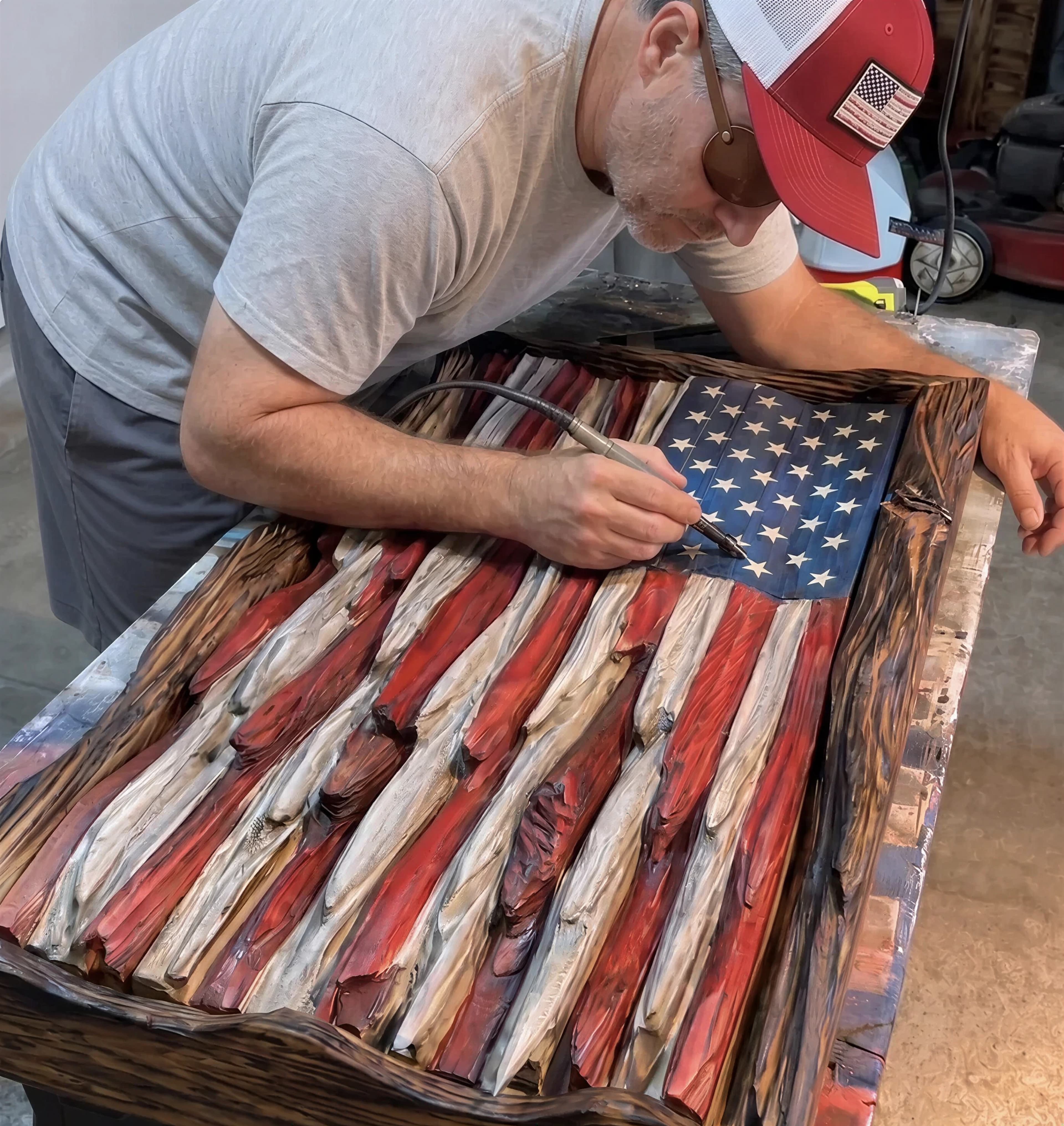 Mark handcrafting a wooden American flag in the workshop